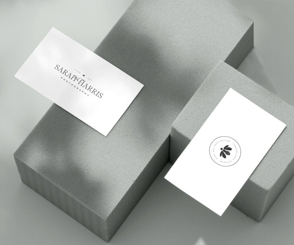 A business card mockup for fine art photographer Sarah Harris, featuring the company logo on one side, and the logo submark with a bee icon on the reverse.